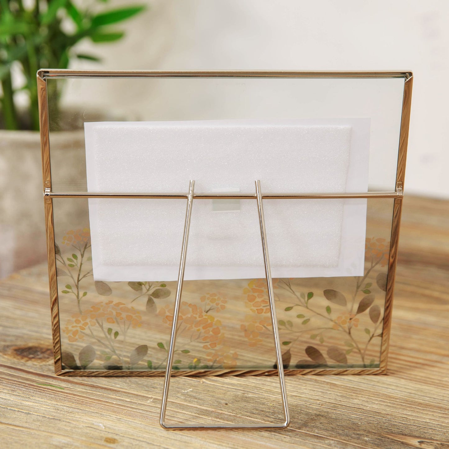 Glass display case with a white card on a wooden surface