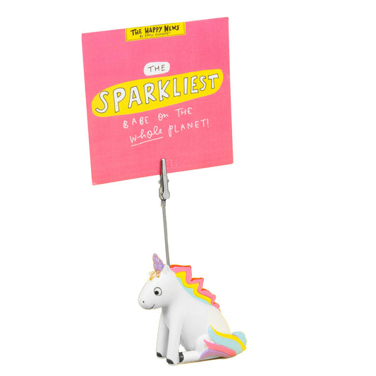 Unicorn-shaped clip with a pink sign reading 'The Sparkliest & Are on the Whole Planet' on a white background