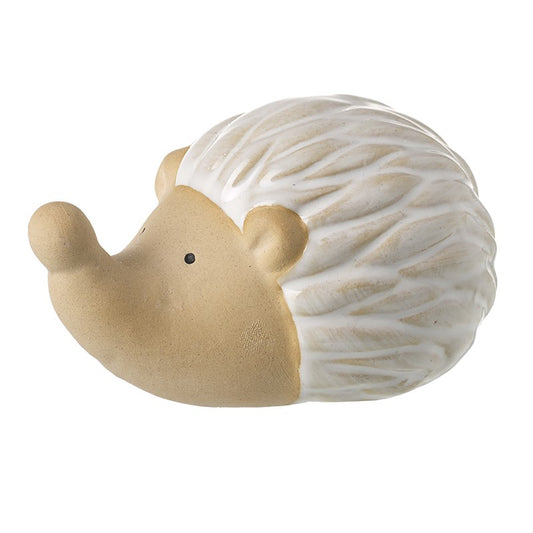 Ceramic hedgehog figurine with beige body and white back on a white background