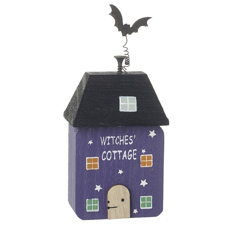 Decorative Halloween house with 'Witches' Cottage' text on a white background