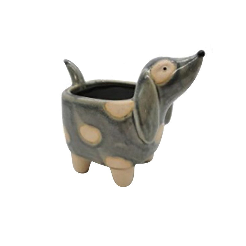 Ceramic dog-shaped planter on a white background