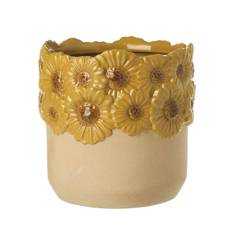 Ceramic planter with yellow floral designs on a white background