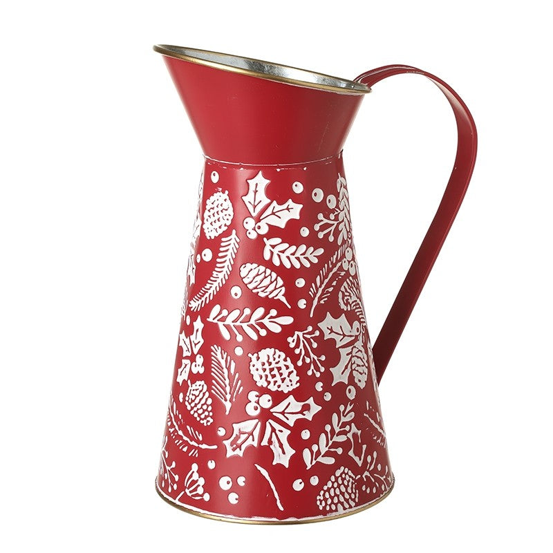 Red pitcher with white floral patterns on a white background