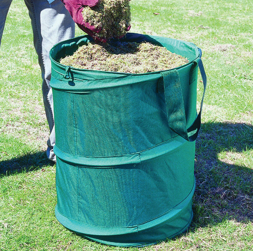 Green garden waste bin being used outdoors on grass