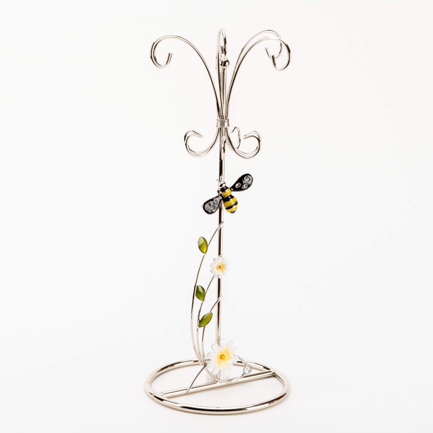 Decorative metal stand with floral design on a white background