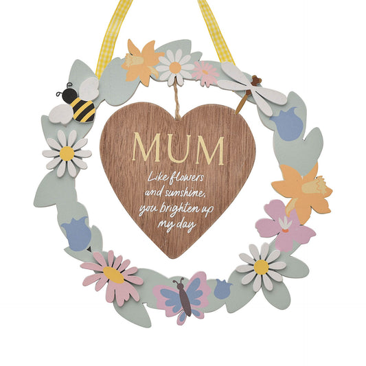 Decorative wreath with a wooden heart and floral elements on a white background