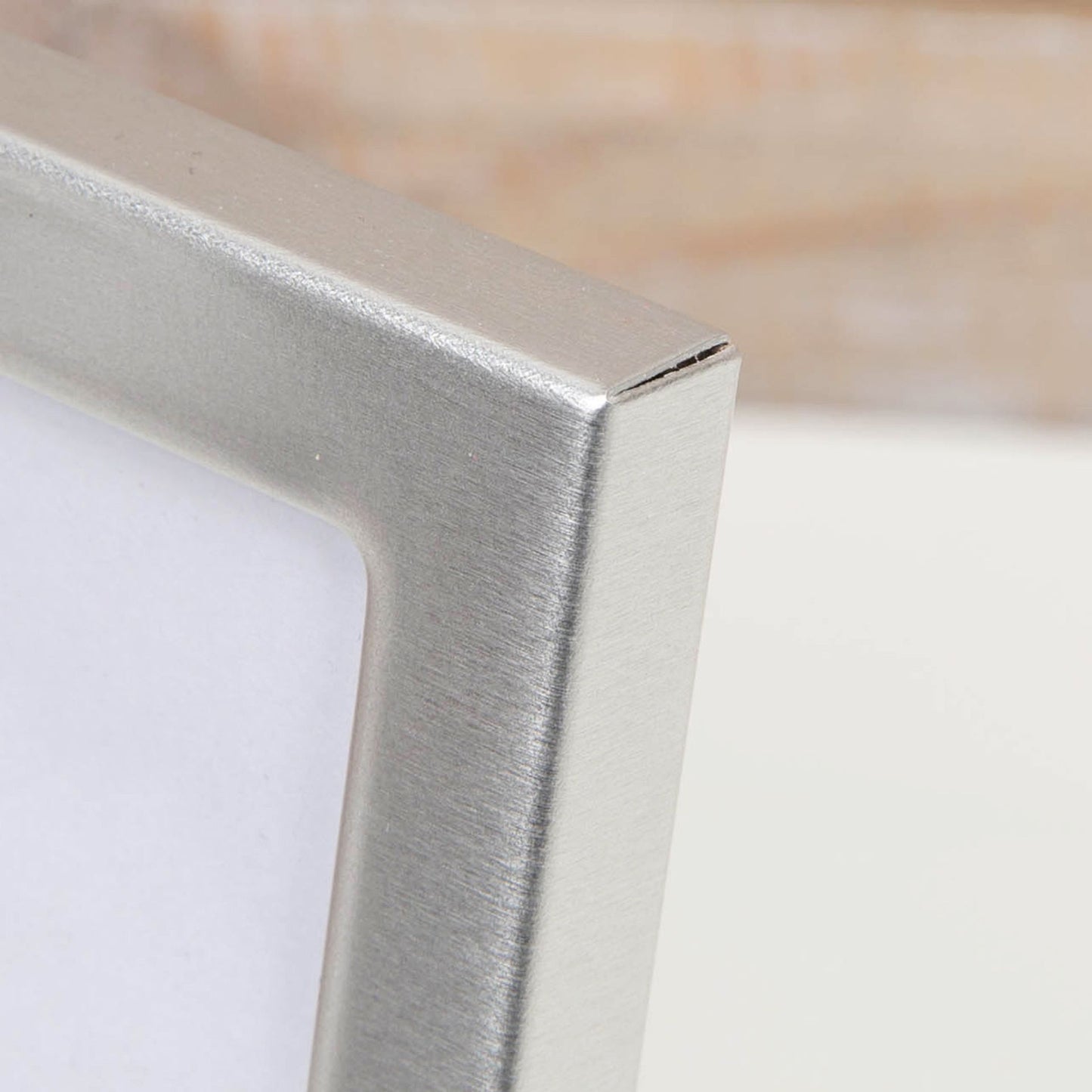 Close-up of a metallic frame corner on a white background