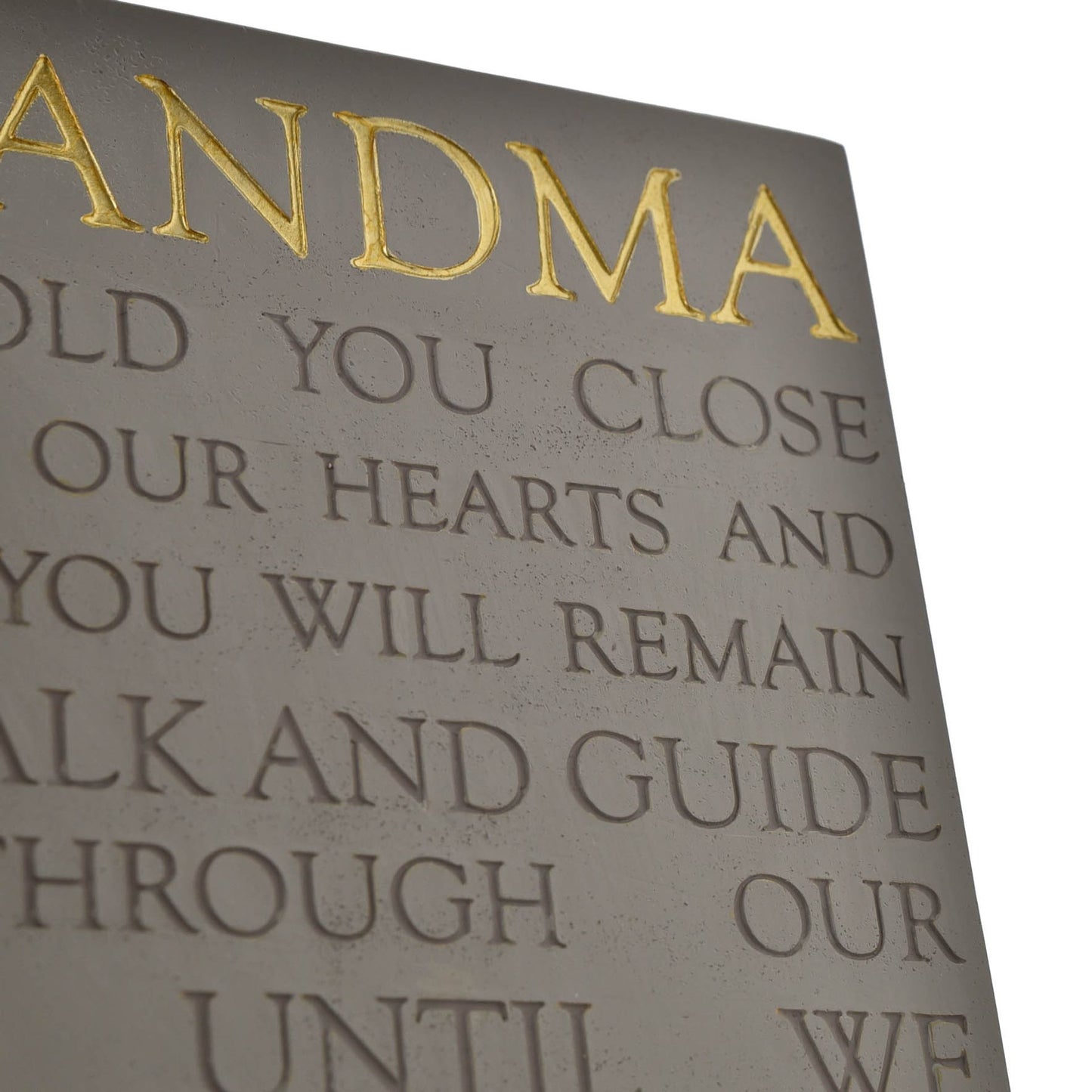 Decorative plaque with gold text on a gray background
