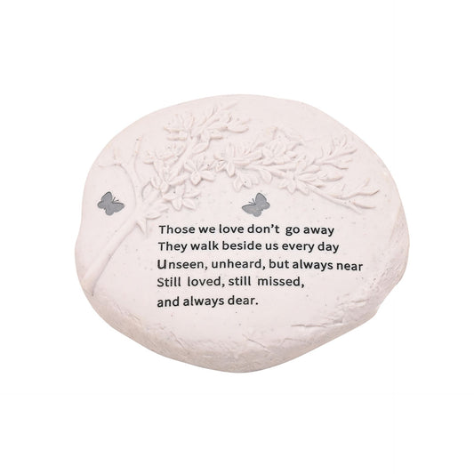 Decorative stone with engraved text and butterfly designs on a white background