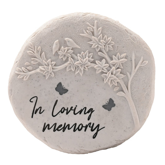 Round stone with floral embossing and 'In loving memory' text on a white background
