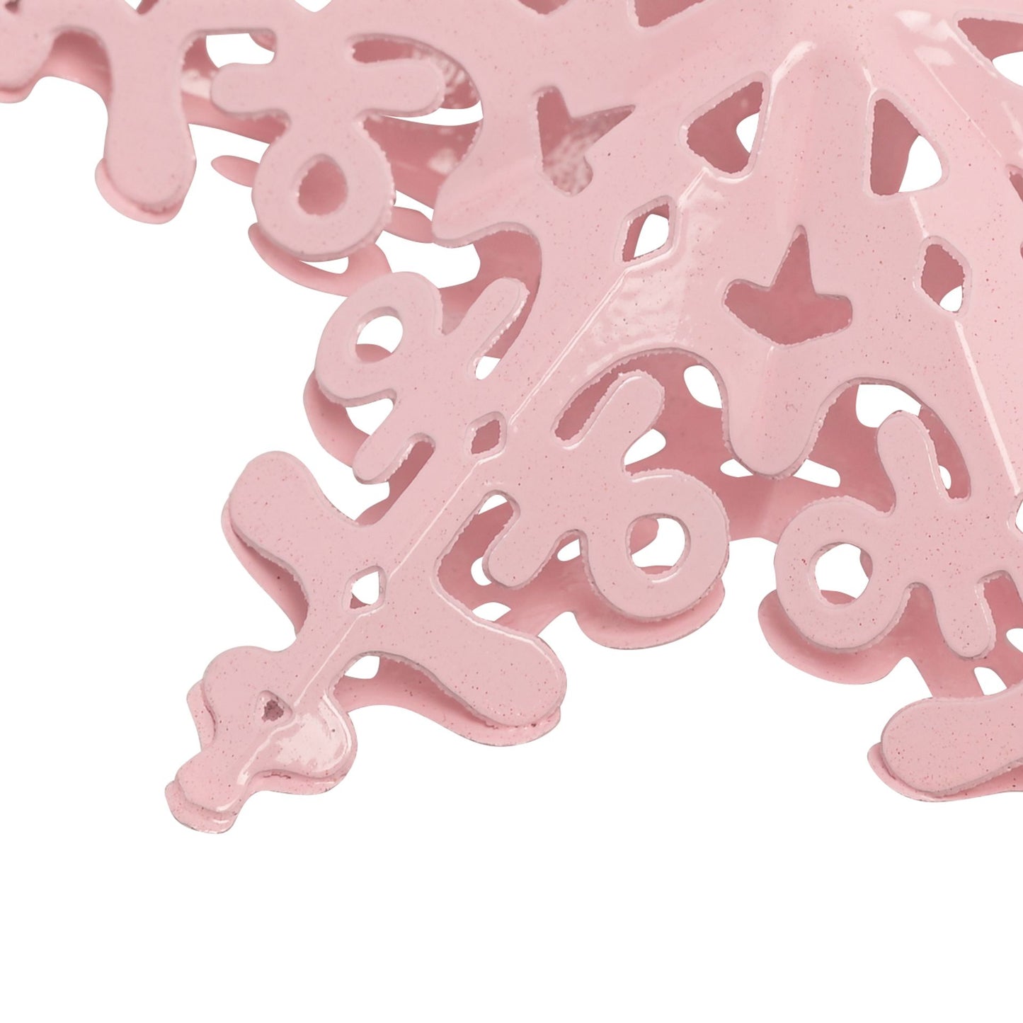 Pink decorative item with cut-out patterns on a white background