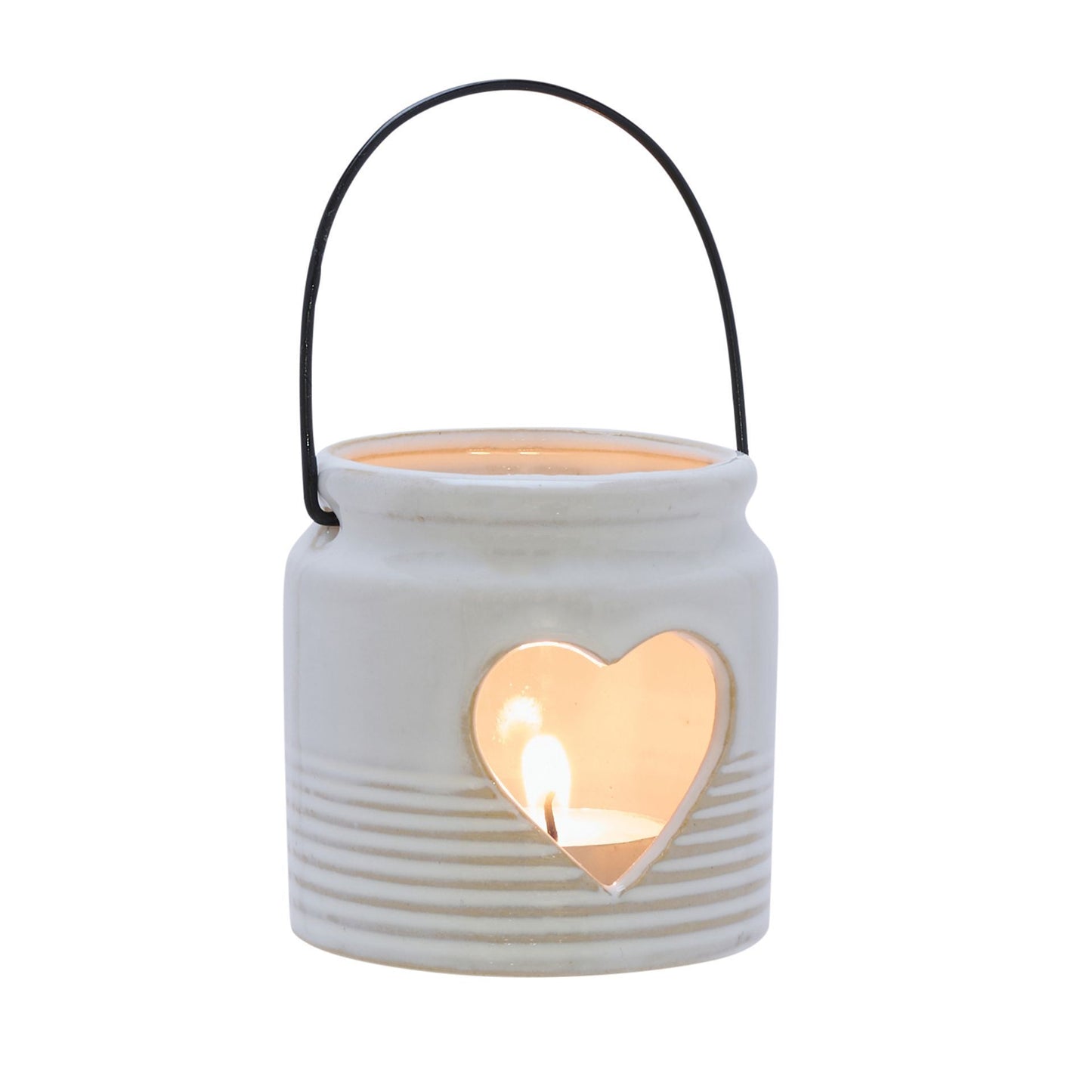 White ceramic lantern with a heart-shaped cutout and a lit candle inside on a white background