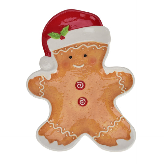 Gingerbread man-shaped plate with a Santa hat on a white background