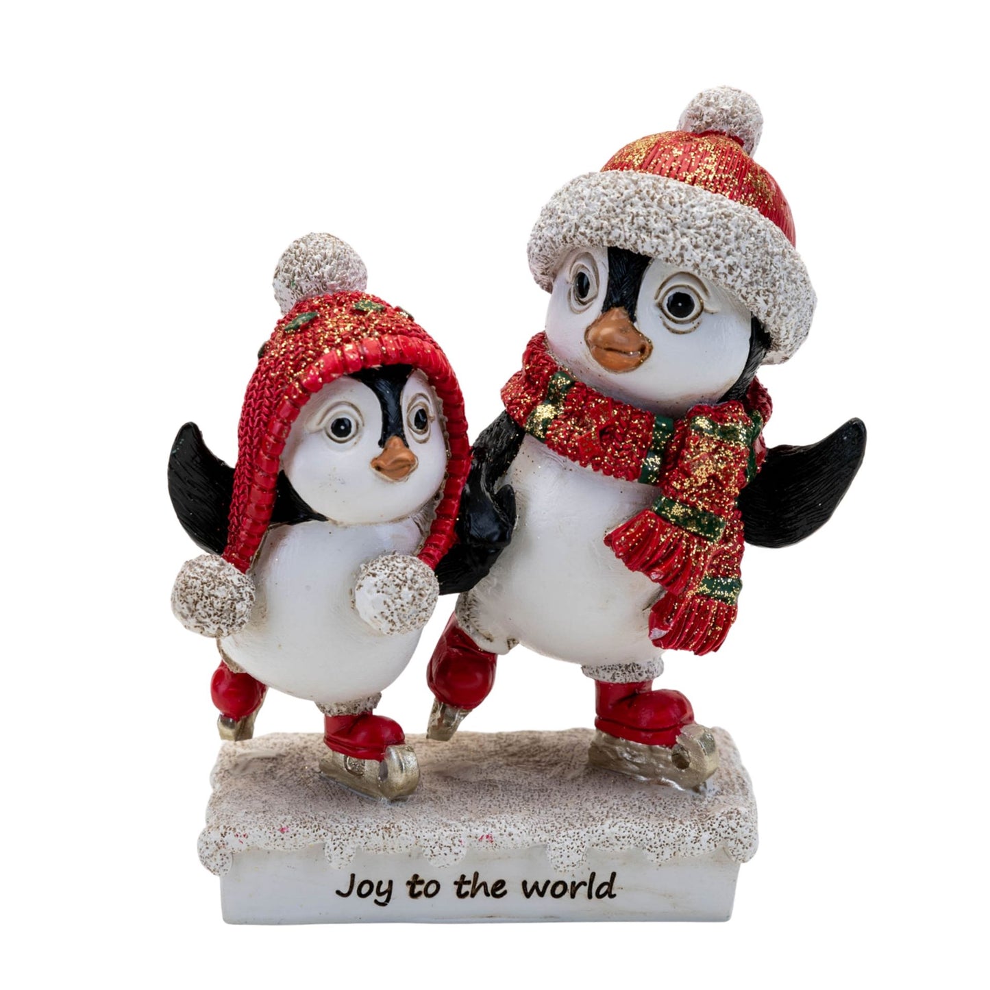 Two penguin figurines wearing festive hats and scarves with 'Joy to the world' text on a white background.
