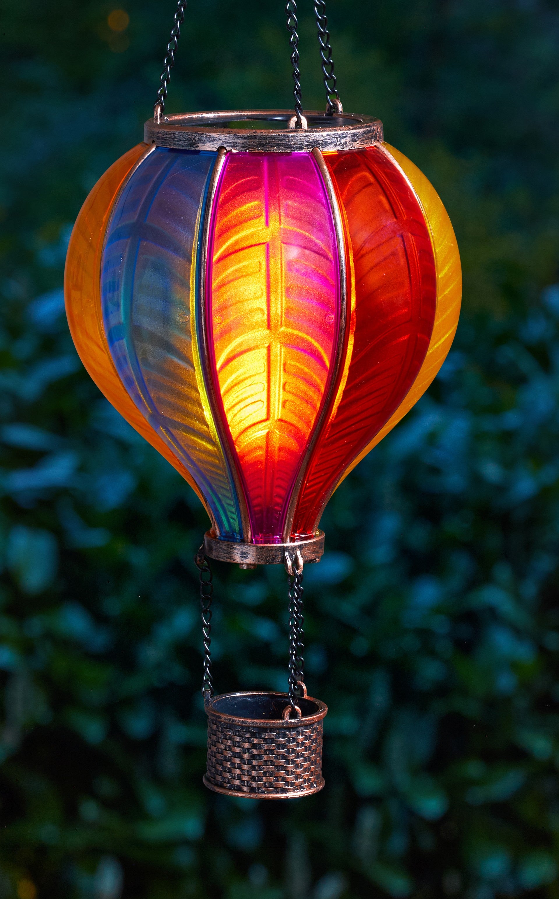 Colorful hanging lantern with a gradient from blue to red against a blurred green background
