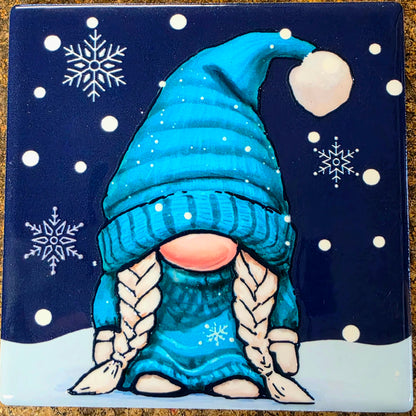 Gnome with a blue hat and scarf on a snowy night background