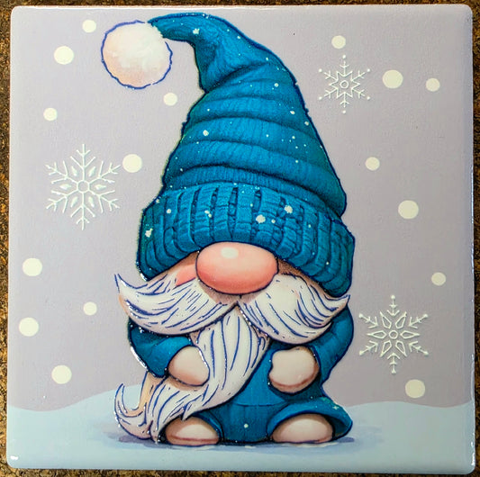 Gnome with a blue hat and beard on a snowy background with snowflakes