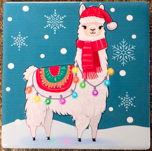 Illustration of a llama wearing a Santa hat and scarf with colorful lights on a blue background with snowflakes.