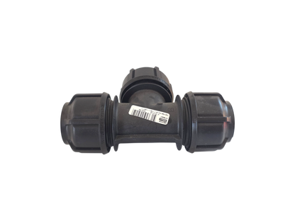 A black plastic T-shaped pipe fitting with threaded connectors on each arm and a white barcode label in the center, isolated on a white background.