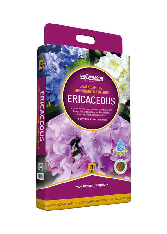 Gardening product packaging for Ericaceous plants with purple and white flowers on a white background.