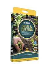 Seed and cutting packaging with a hand holding plants and soil background