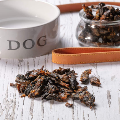 Hollings 100% Natural Chicken Hearts on a table next to a white dog bowl and a dog lead