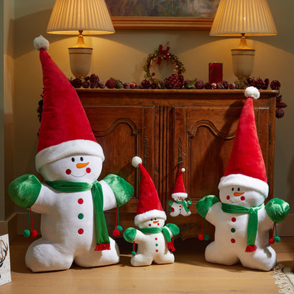 Decorative snowman and Santa Claus figures with red hats and green scarves in a festive setting.