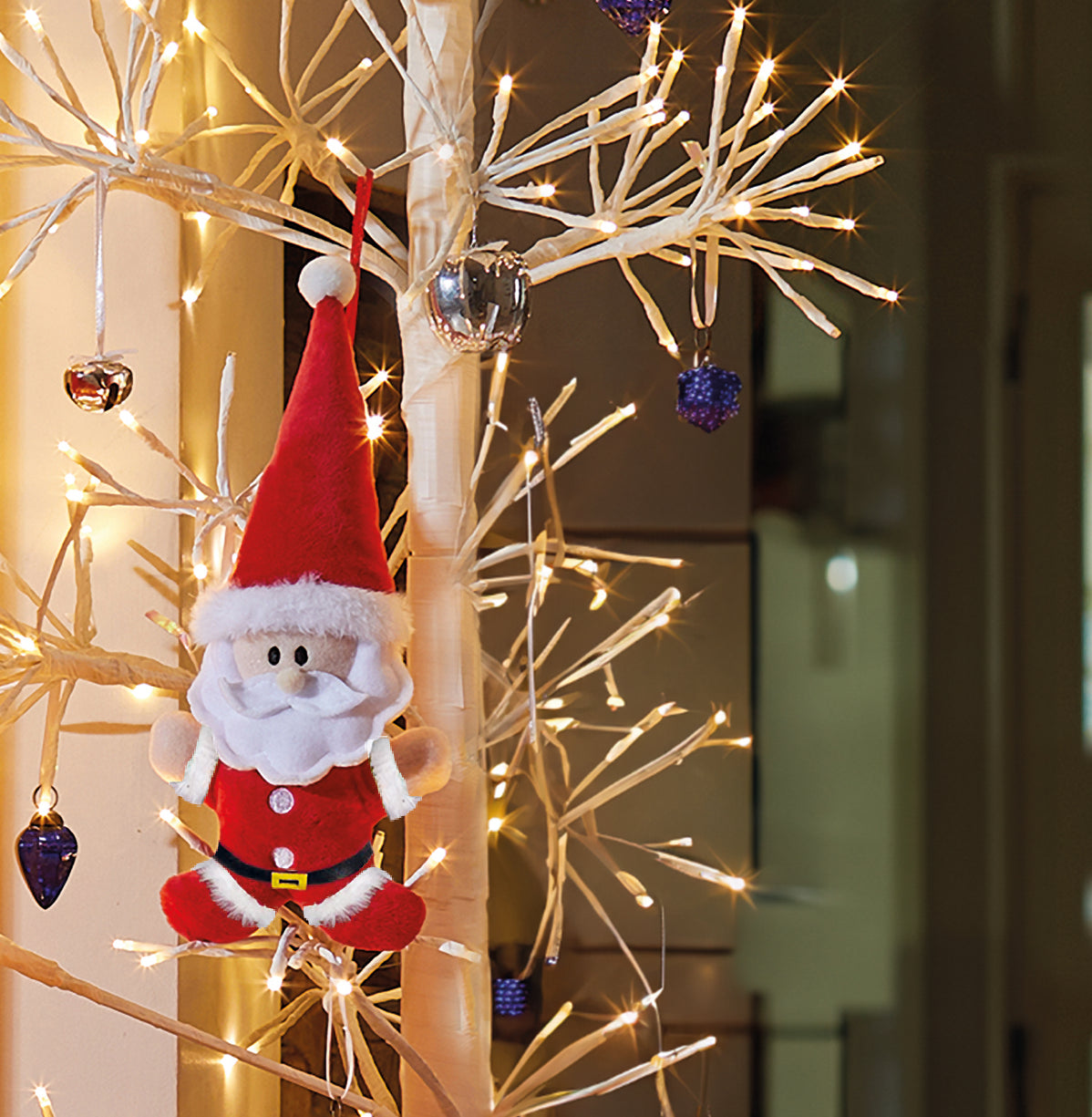 Santa Claus ornament hanging on a decorated tree with lights and ornaments.