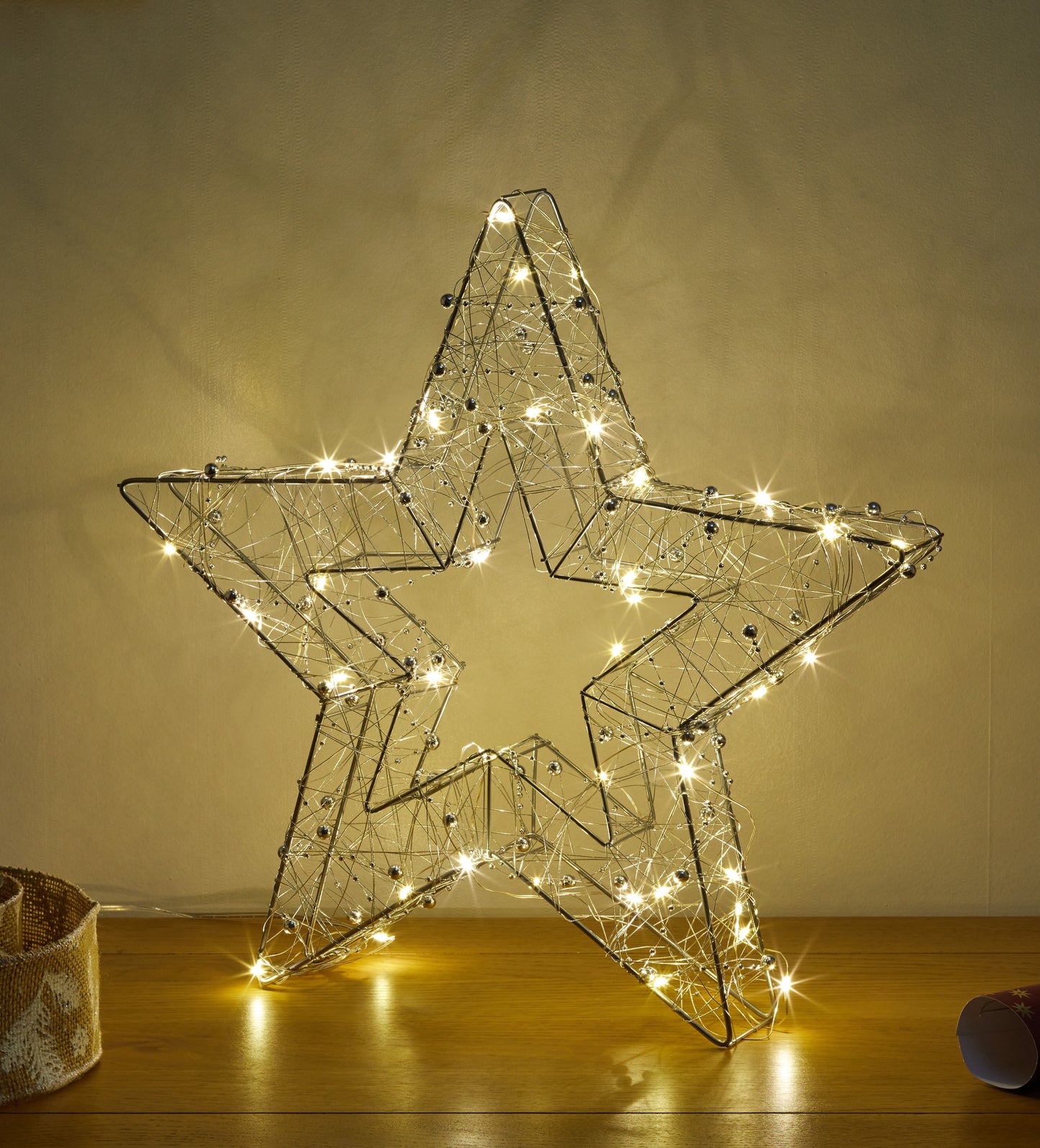 Decorative star light on a wooden surface with a neutral background