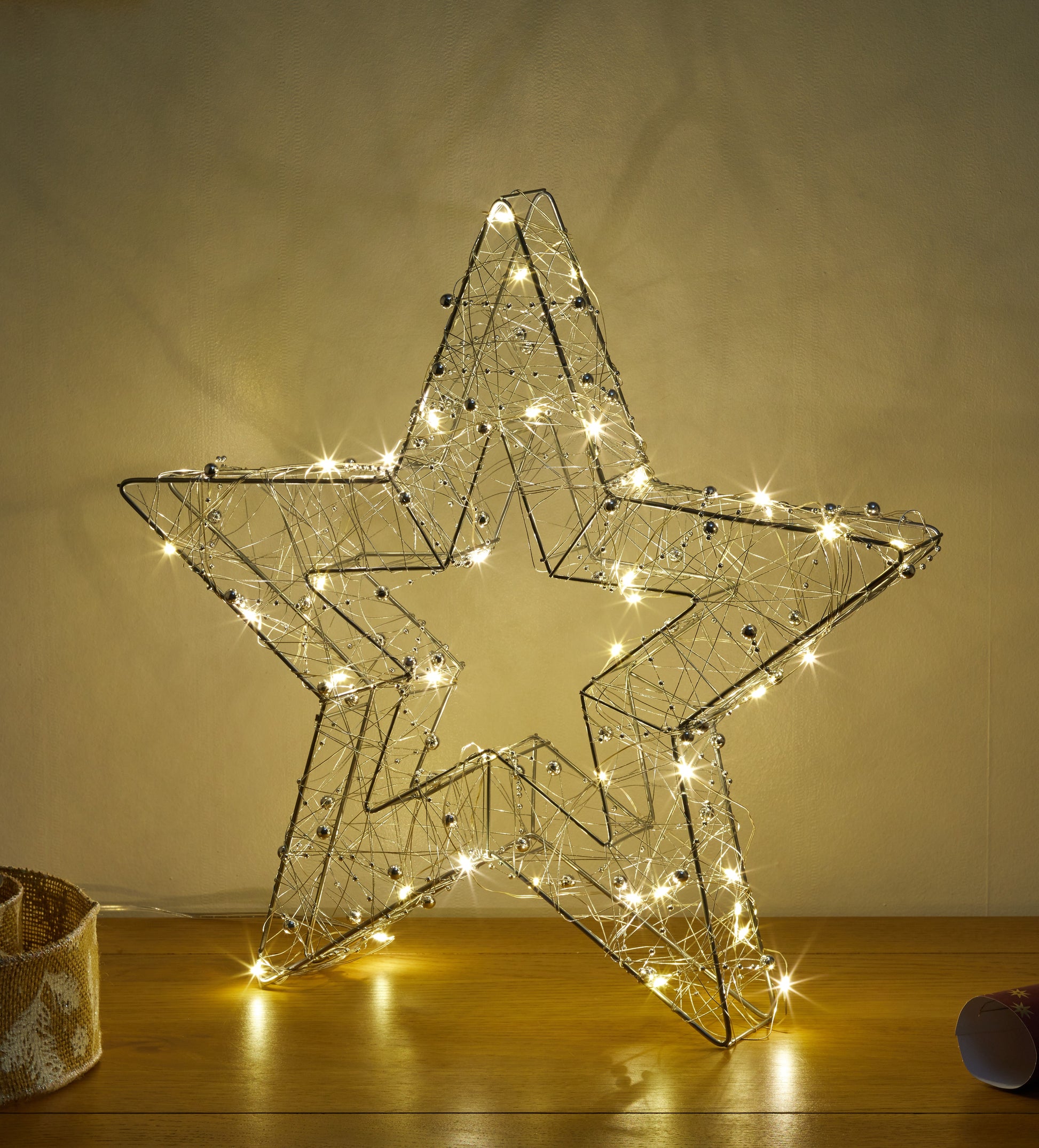 Decorative star light on a wooden surface with a neutral background