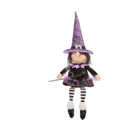 Toy witch with a purple hat and striped outfit on a white background