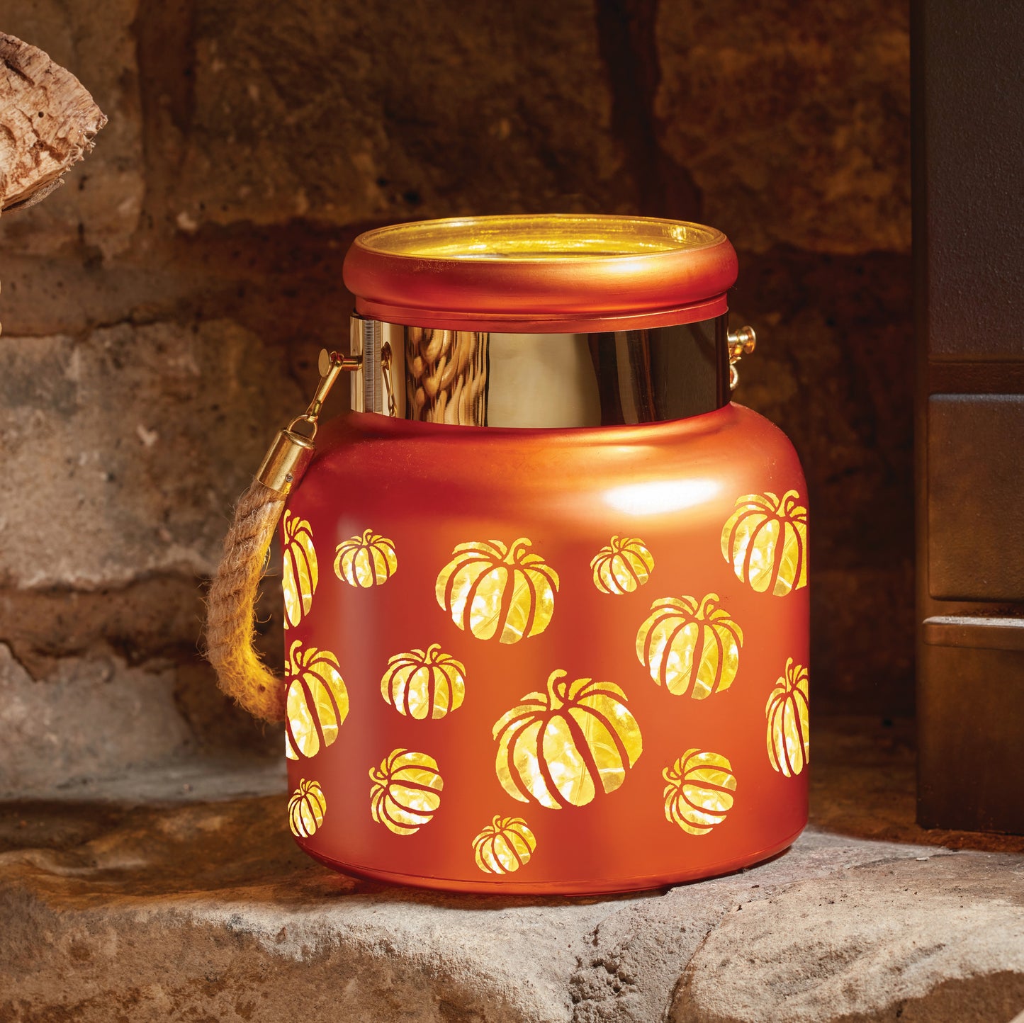 Decorative lantern with pumpkin pattern on a stone surface