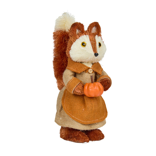 Stuffed toy fox in a brown outfit holding a small pumpkin on a white background
