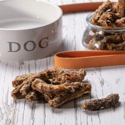Hollings 100% Natural Chicken Necks on a table next to a white dog bowl and a dog lead