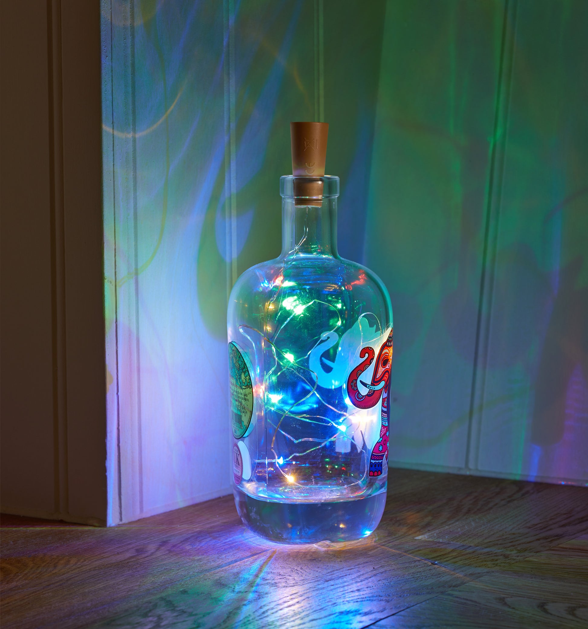 Decorative bottle with string lights against a colorful background