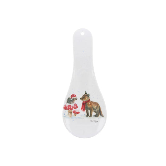 White ceramic spoon rest with dog and cat design on a white background