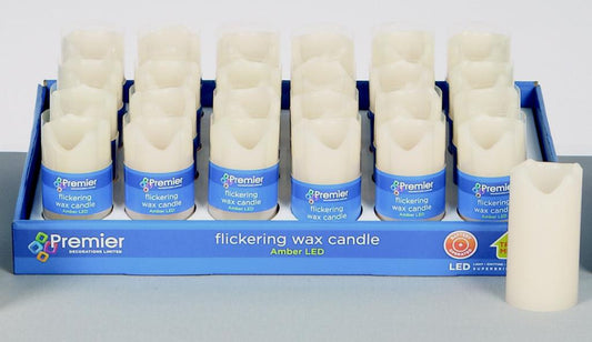 Box of Premier flickering wax candles on a gray surface with a white background