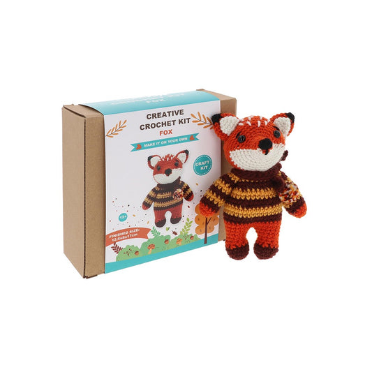 Crocheted fox toy with a matching box labeled 'Creative Crochet Kit Fox' on a white background.
