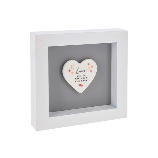 Heart-shaped ceramic plaque with 'Love you to the moon and back' text in a white frame on a white background