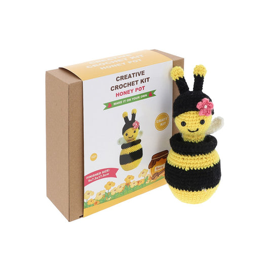 Crocheted bee toy with a pink flower on its head next to a 'Creative Crochet Kit Honey Pot' box.