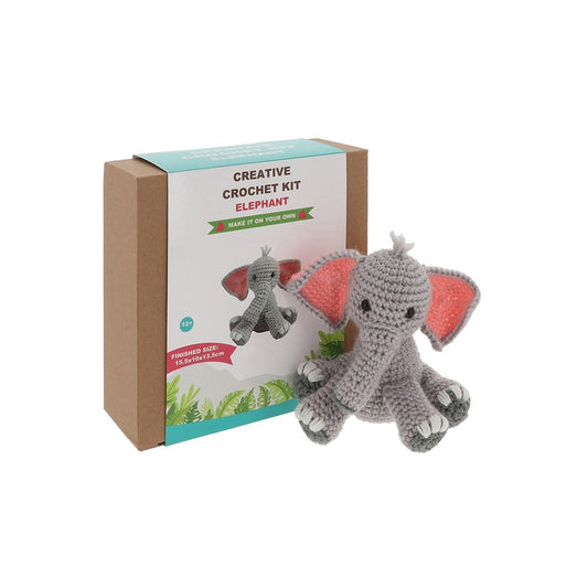 Crocheted elephant toy next to a box labeled 'Creative Crochet Kit Elephant' on a white background