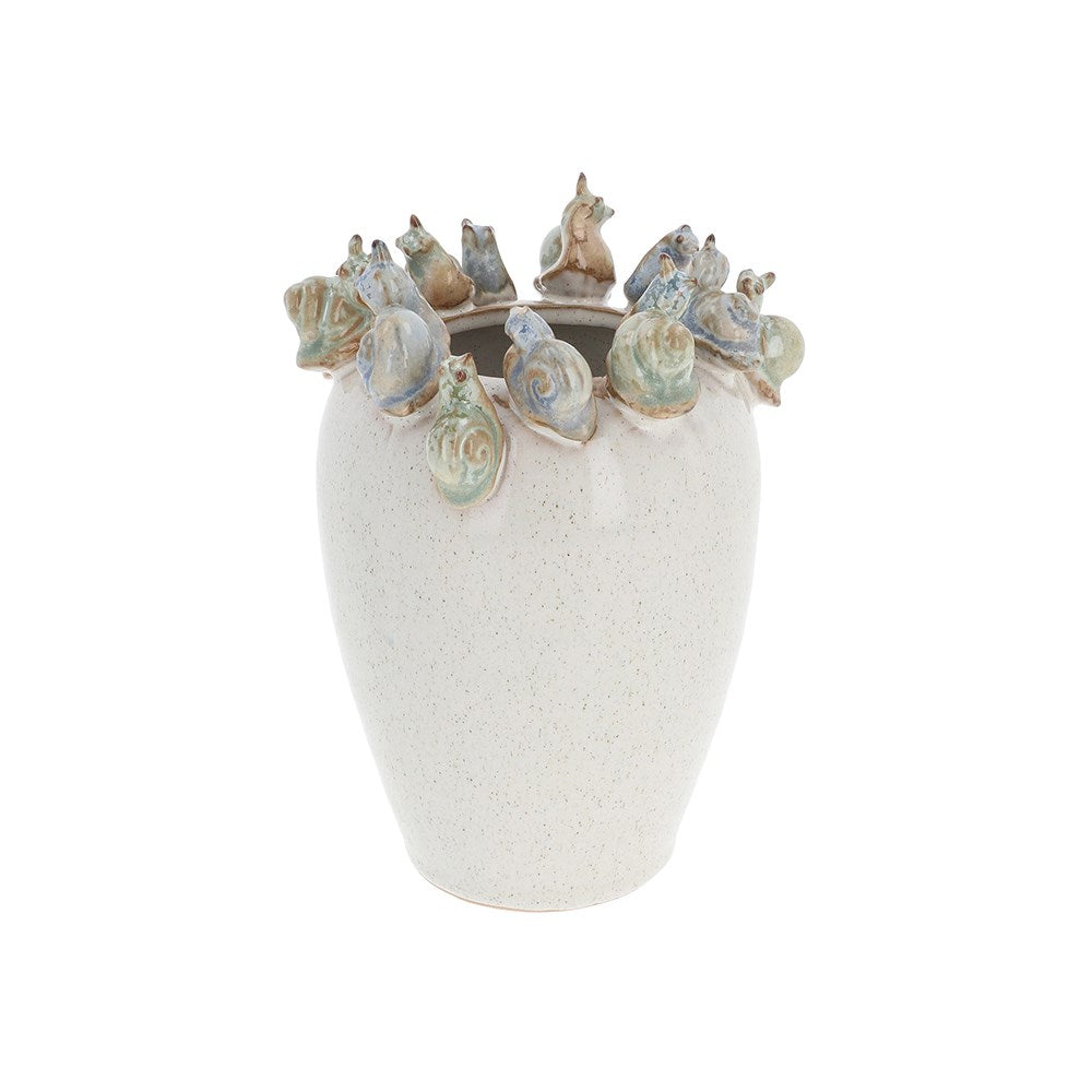 Decorative vase with shell designs on a white background