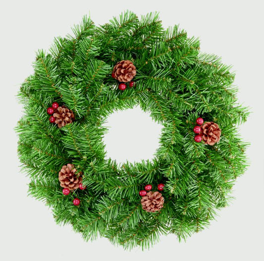 Green Christmas wreath with pine cones and berries on a light gray background