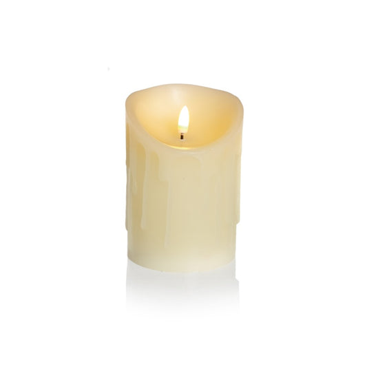 Cream-colored candle with a flame on a white background