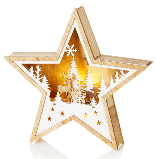 Wooden star-shaped lantern with cut-out designs of a deer and trees on a white background