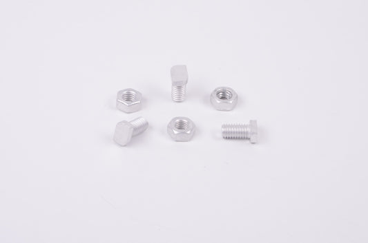 Set of metal screws and nuts on a white background