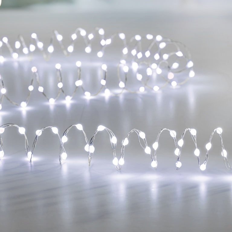String of white LED lights on a reflective surface