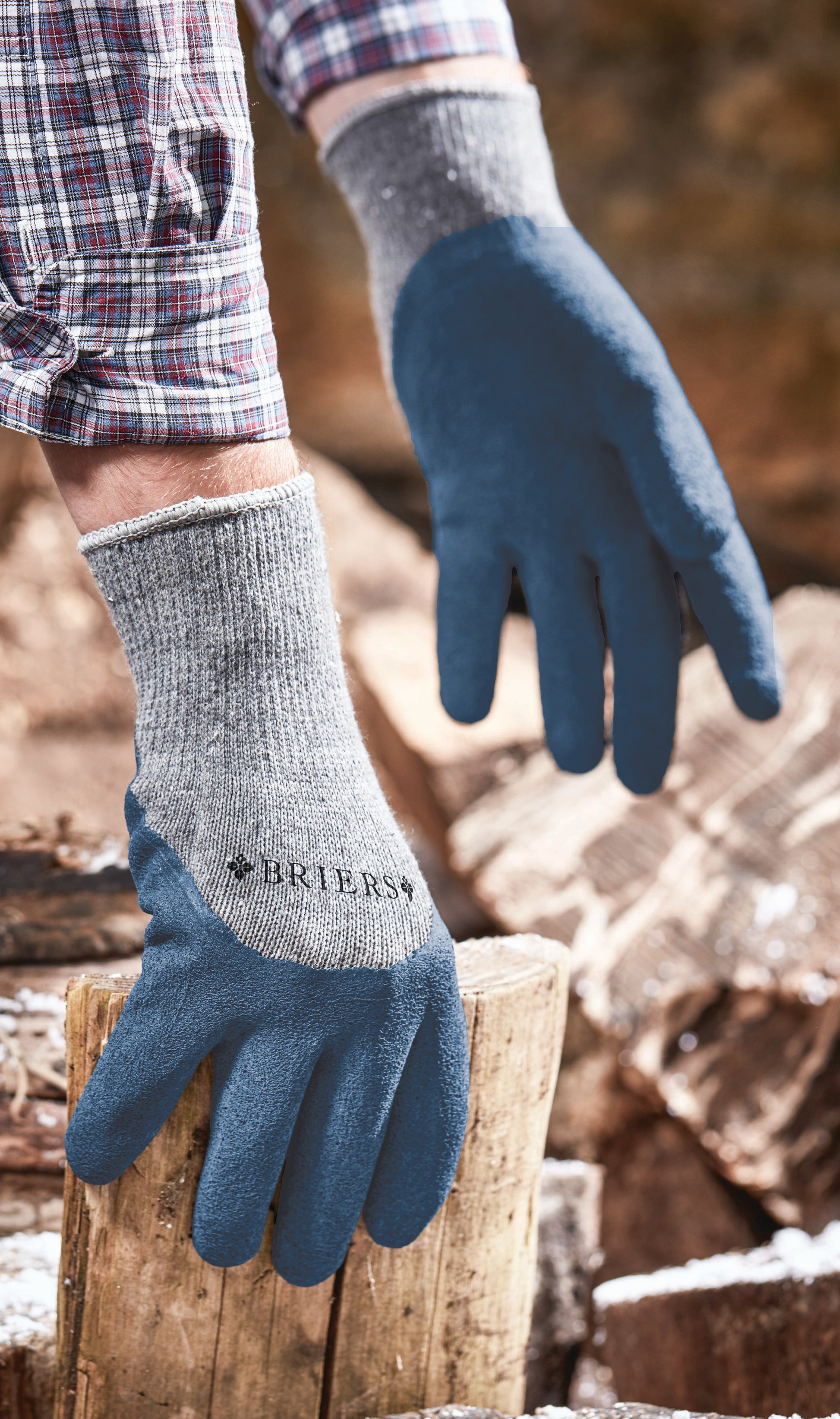 Person wearing blue gloves and gray socks with 'Briers' branding, standing on a log.