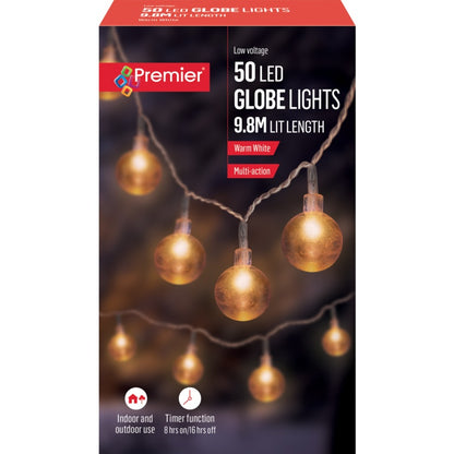 Box of Premier 50 LED globe lights with warm white bulbs on a dark background