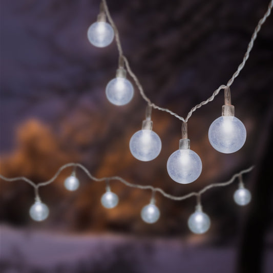 String of light bulbs against a blurred natural background